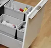 A close-up view of a kitchen waste bin system with multiple compartments, partially pulled out from a cabinet. Produktbild-Vorschau