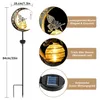 A solar garden light with a fairy and moon design, shown with close-up details of its features and dimensions. Produktbild-Vorschau