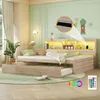 A bedroom scene featuring a wooden daybed with a pull-out trundle bed, illuminated by LED lights. Decorative elements and a plant add to the ambiance. Produktbild-Vorschau