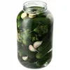 A glass jar filled with pickles, dill, and garlic. Podgląd zdjęcia produktu