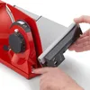 A close-up shot of a red food slicer, with a hand pressing a button on the side. Produktbild-Vorschau