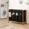 A laundry cart with four compartments and a washing machine in the background. Anteprima dell’immagine prodotto