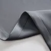 A close-up view of a folded dark gray fabric, likely a curtain, showing its texture and stitching. Produktbild-Vorschau