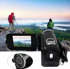 Two people are on a mountain top, one taking a photo with a camcorder, the other looking at the view. The camcorder is in the foreground. Produktbild-Vorschau