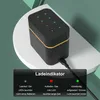 A black and gold battery charging box with LED indicators is shown on a white surface with a green background. Produktbild-Vorschau