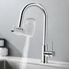 A chrome kitchen faucet with a white water filter attached, dispensing water into a sink. Produktbild-Vorschau