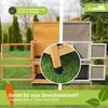 A split image showing two sides of a two-story animal hutch, one in natural wood and the other in gray, set against a grassy outdoor background with trees. Produktbild-Vorschau