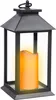 A black lantern with a yellow LED candle inside, set against a white background. Produktbild-Vorschau