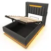 A bed frame with its storage compartment open and the mattress support raised, showing the internal storage space and LED lighting. Podgląd zdjęcia produktu