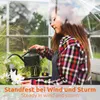 A young woman watering plants in a greenhouse. Produktbild-Vorschau