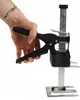 A hand is holding a tool that appears to be a furniture lifter. Náhled obrázku produktu