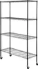 A black metal wire shelving unit with four shelves and wheels, shown against a white background. Produktbild-Vorschau