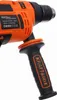 Close-up of the handle and part of the body of an orange and black power drill. Voir les images du produit