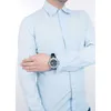 A man wearing a light blue dress shirt is shown from the chest down, with his left arm crossed over his chest. He is wearing a watch on his left wrist. Produktbild-Vorschau