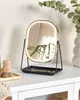 A vanity mirror with LED lighting sits on a white dresser, next to a wooden brush and a vase with greenery. Náhled obrázku produktu