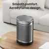 A heater is placed on a wooden table in front of a sofa. Produktbild-Vorschau