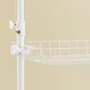 A close-up view of a white wire basket attached to a white pole, likely part of a shelving unit or garment rack. Produktbild-Vorschau