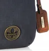A close-up view of a dark blue handbag with a perforated texture, featuring a metallic brand logo and a brown leather tag with the brand name. Produktbild-Vorschau