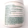 The image shows the side of a product container with text and some small orange particles. Podgląd zdjęcia produktu