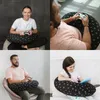 Collage of four images showing people of different ages using a black and white patterned pillow while playing video games or reading. Anteprima dell’immagine prodotto