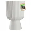 A white planter on a pedestal with a product tag attached. Podgląd zdjęcia produktu