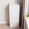 A white wooden cabinet with four doors stands against a light gray wall. Náhled obrázku produktu