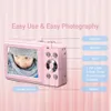 A pink digital camera is shown with a child's face on its screen. Text overlays describe its features. Produktbild-Vorschau