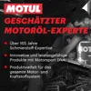 A mechanic working on a car engine with Motul branding prominently displayed. Produktbild-Vorschau