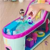 A child's hand is playing with a dollhouse toy set that includes a doll and a cat figure near a pool. Anteprima dell’immagine prodotto