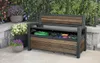 A storage bench with its lid open, revealing garden tools and a hose, placed on a patio with potted plants. Produktbild-Vorschau