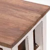 A close-up view of the corner of a wooden table with a white base. Náhled obrázku produktu