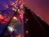 A close-up shot of colorful LED string lights wrapped around a reflective surface, creating a festive and magical atmosphere. Produktbild-Vorschau