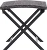 A close-up view of a folding table with a woven top and black metal legs. Náhľad obrázku produktu