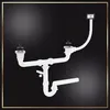 A white sink drain assembly with two basins and a trap is shown against a black background. Anteprima dell’immagine prodotto