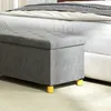 A gray storage bench with yellow legs sits in front of a bed. Anteprima dell’immagine prodotto