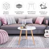 A small white round table with wooden legs is placed in a living room setting. Produktbild-Vorschau