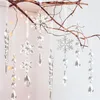 Clear acrylic snowflake and icicle ornaments hanging from branches, with blurred bokeh lights in the background. Produktbild-Vorschau