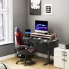 A gaming desk setup in a room with a window. Voir les images du produit