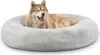 A dog lying in a round, plush dog bed. Náhled obrázku produktu
