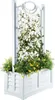 A white planter box with a trellis, filled with green plants and yellow flowers. Podgląd zdjęcia produktu