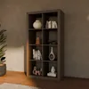 A dark brown wooden bookshelf with eight compartments, filled with decorative items and books, placed against a textured gray wall. Produktbild-Vorschau
