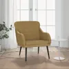 A brown velvet armchair is placed in a room with large windows and sheer curtains. A small white side table with a glass of water is next to the armchair. Voir les images du produit