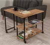 A wooden side table with shelves next to a grey sofa. Voir les images du produit