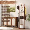 A wooden coat rack with shelves and hooks, next to a wooden cabinet, with a painting on the wall. Anteprima dell’immagine prodotto