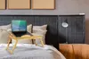A wooden laptop table with a laptop on it is placed on a bed. Produktbild-Vorschau
