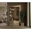 A modern wardrobe is shown open, revealing its interior storage compartments and hanging space. The wardrobe is placed in a well-lit room with a sofa and a large plant visible in the background. Anteprima dell’immagine prodotto