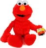 A plush toy of Elmo from Sesame Street is sitting on a white background, holding a small tag with Elmo's image on it. Produktbild-Vorschau