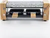 A raclette grill with a granite stone top and wooden sides, shown from the front. Produktbild-Vorschau