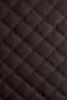 A close-up of quilted brown material. Náhled obrázku produktu
