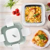 A lunch thermos and a portion of pasta are displayed on a wooden table, along with some cherry tomatoes and greens. Náhľad obrázku produktu